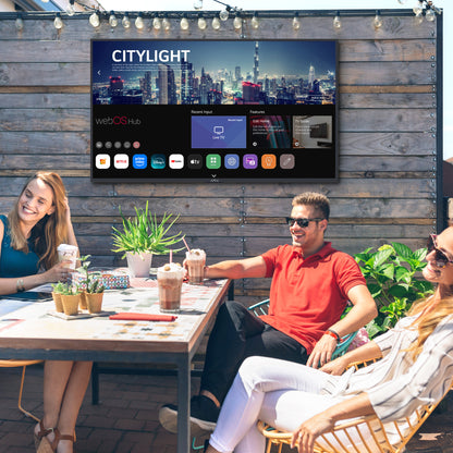 People sitting at a table outdoors with a Neptune Outdoor Smart TV powered by webOS Hub.